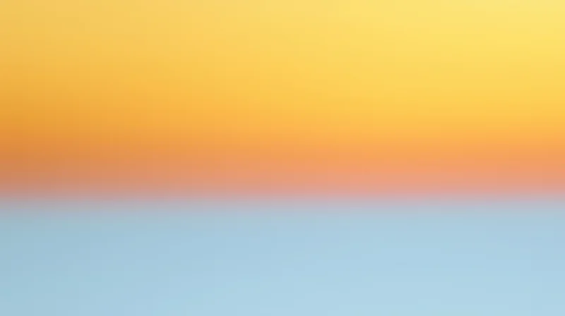 A smooth color gradient transitioning from yellow to blue with a soft orange band in the middle