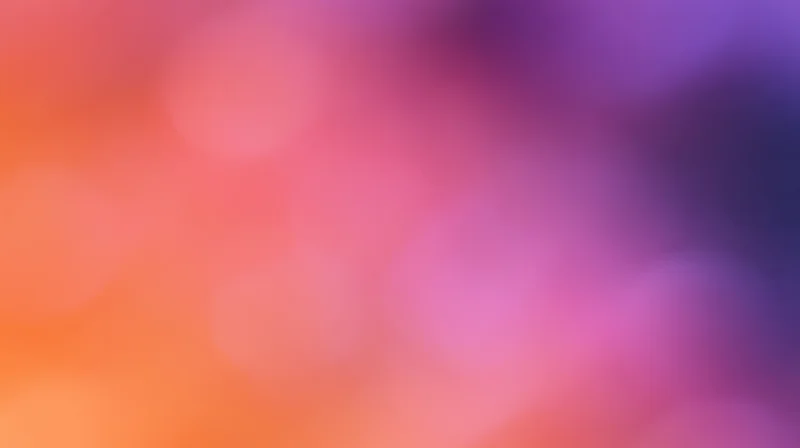 Abstract bokeh background with soft pink, purple, and orange gradient blend