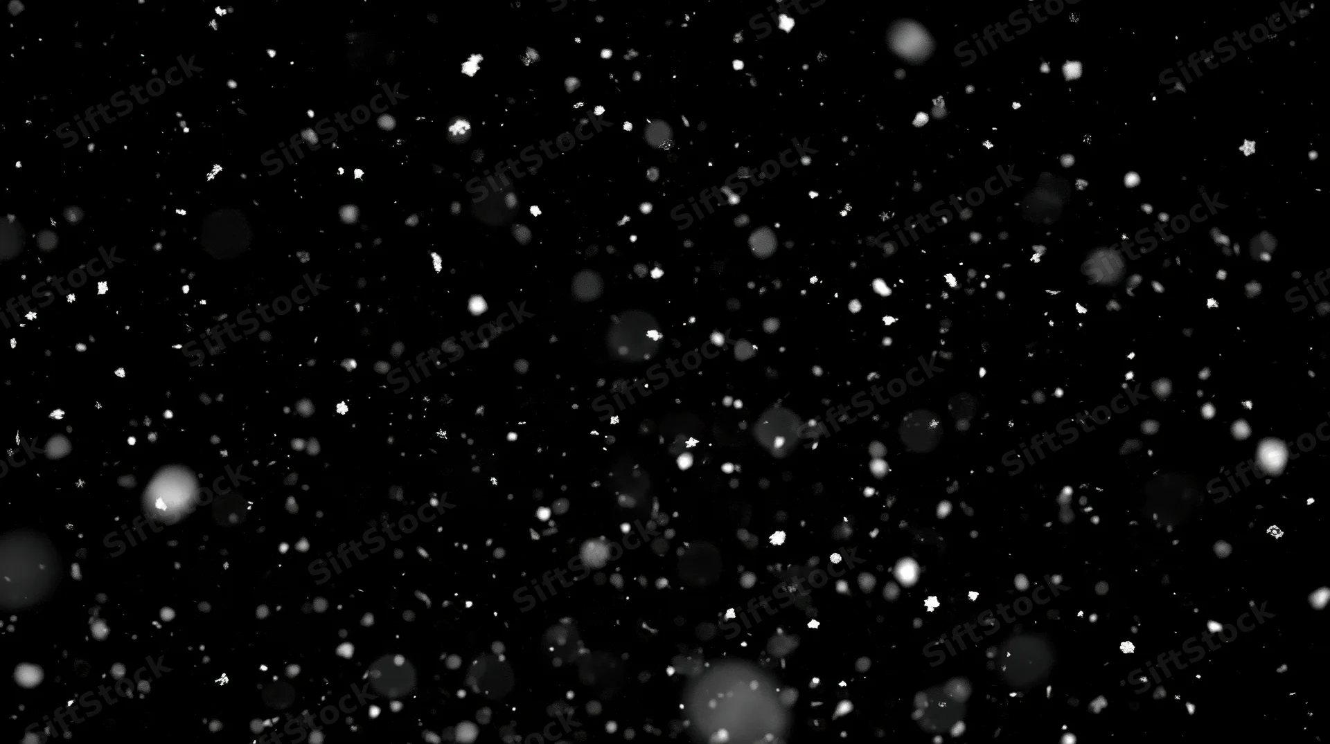 Snowflakes falling in darkness with soft bokeh and scattered light particles