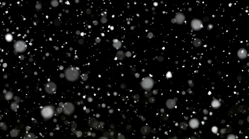Snowflakes falling in motion against a black background with bokeh effect