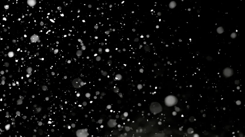 Falling snowflakes against a dark sky at night