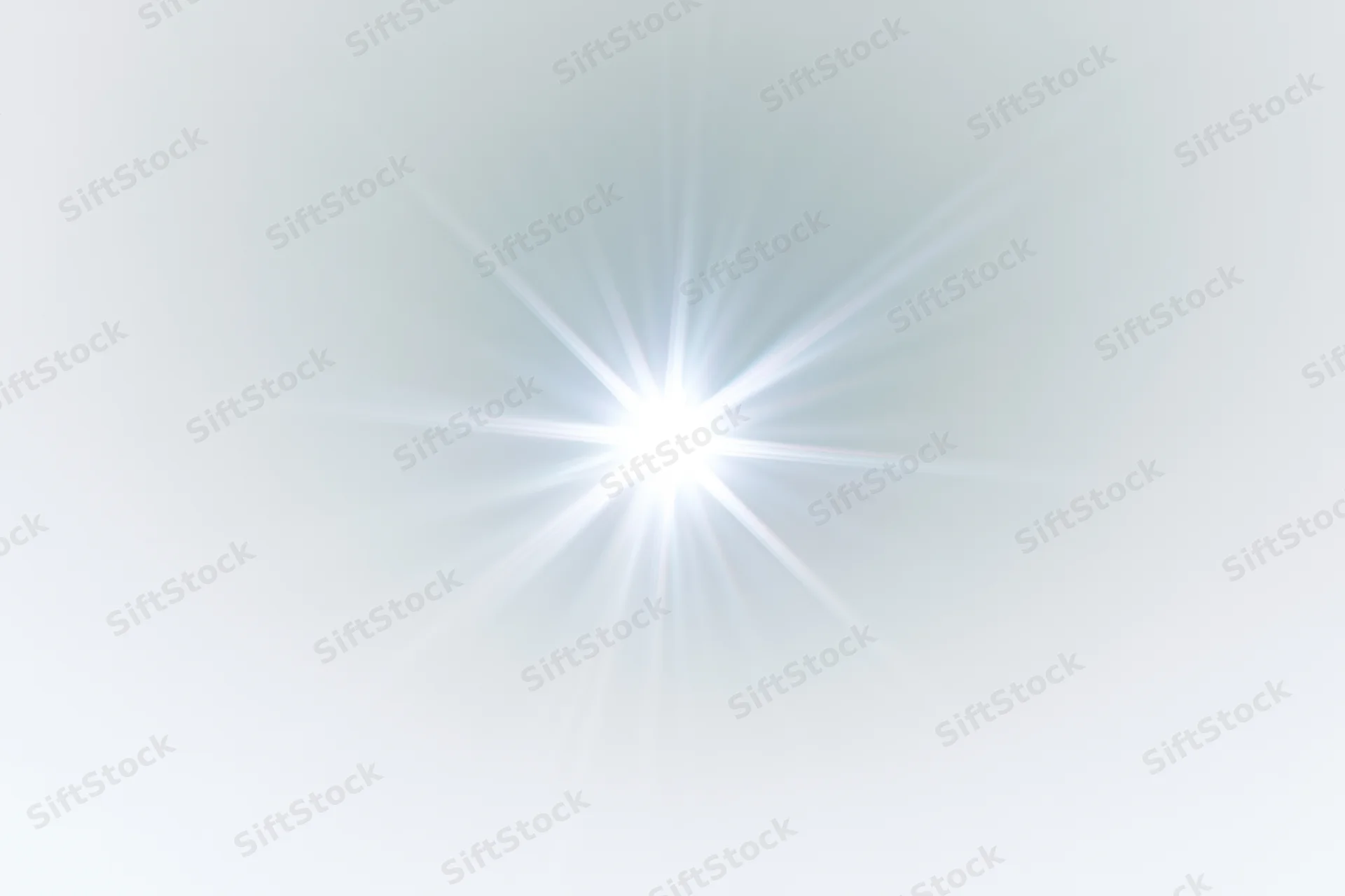 Bright lens flare starburst radiating from center against soft white gradient background