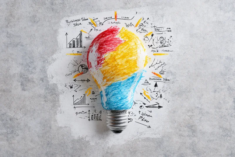 Hand-drawn lightbulb with colorful sketch notes and diagrams around it on textured background