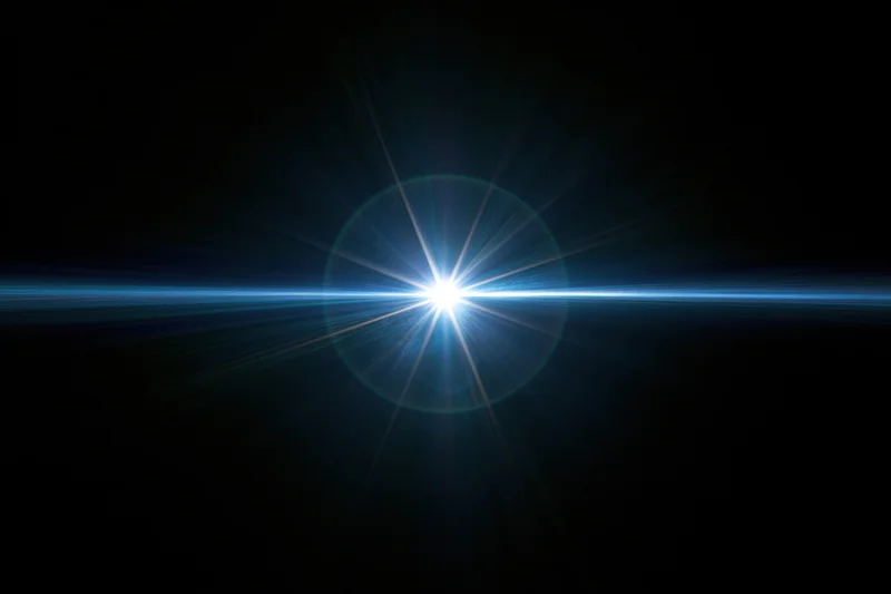 Bright blue-white lens flare centered on black background with horizontal light beam and starburst rays