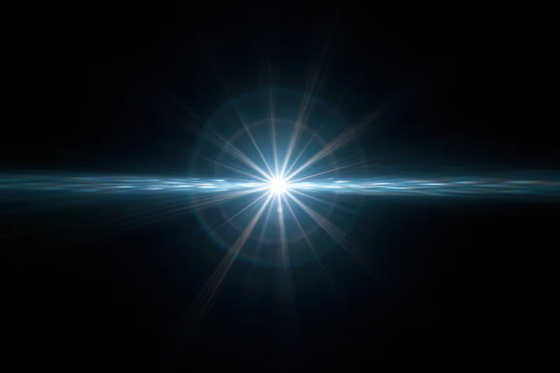 Bright blue-white lens flare centered on dark background with radial light beams and horizontal glow