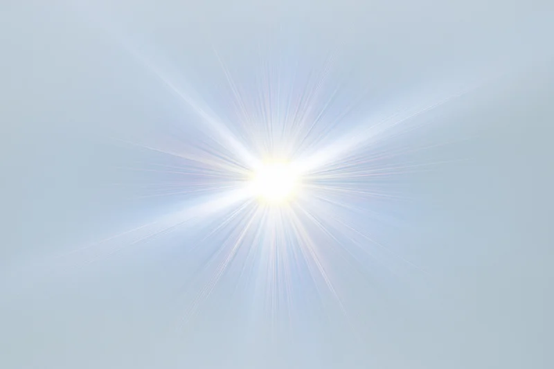 Bright lens flare starburst radiating from center on white background