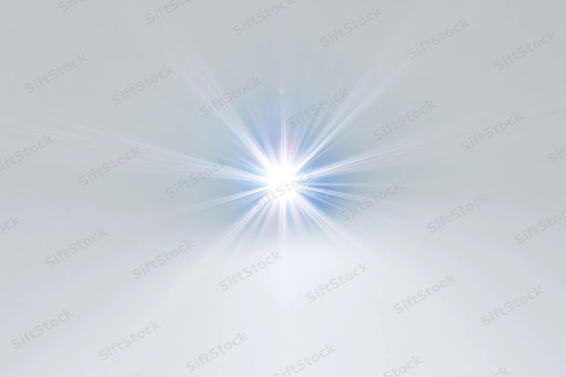 Bright lens flare starburst centered on white background