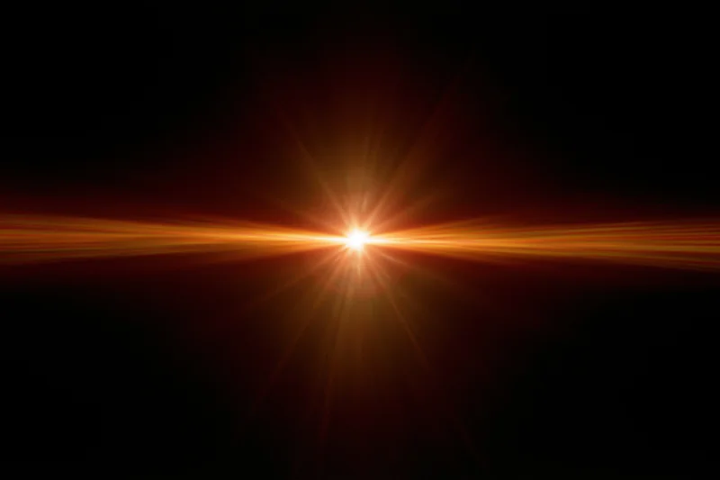 Intense orange-gold lens flare streak radiating horizontally across dark background