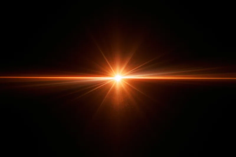 Intense orange-gold lens flare streak radiating horizontally across dark background