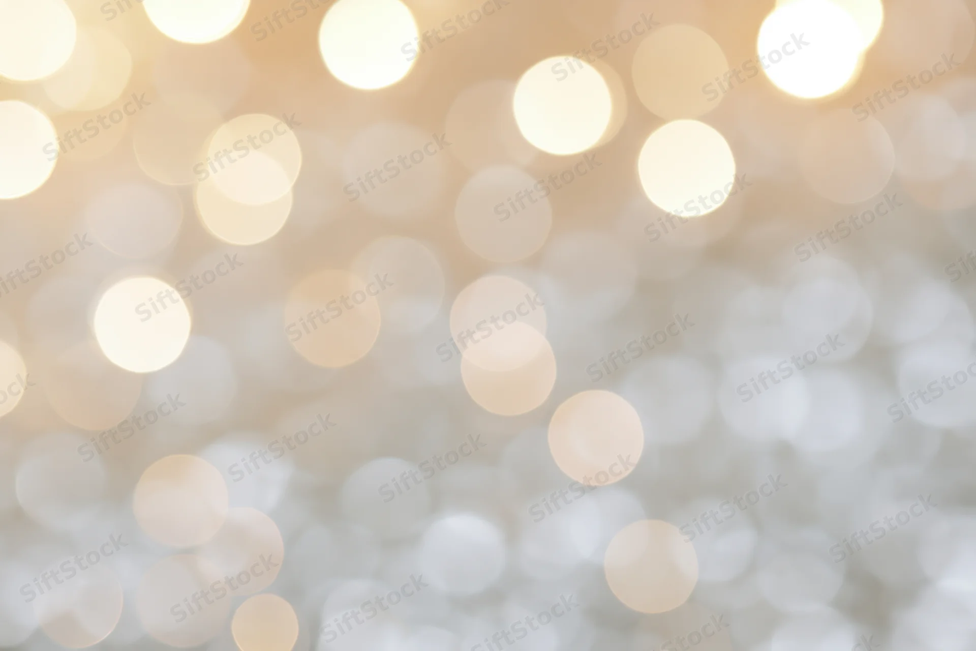 Soft out-of-focus golden light orbs arranged as a festive abstract background