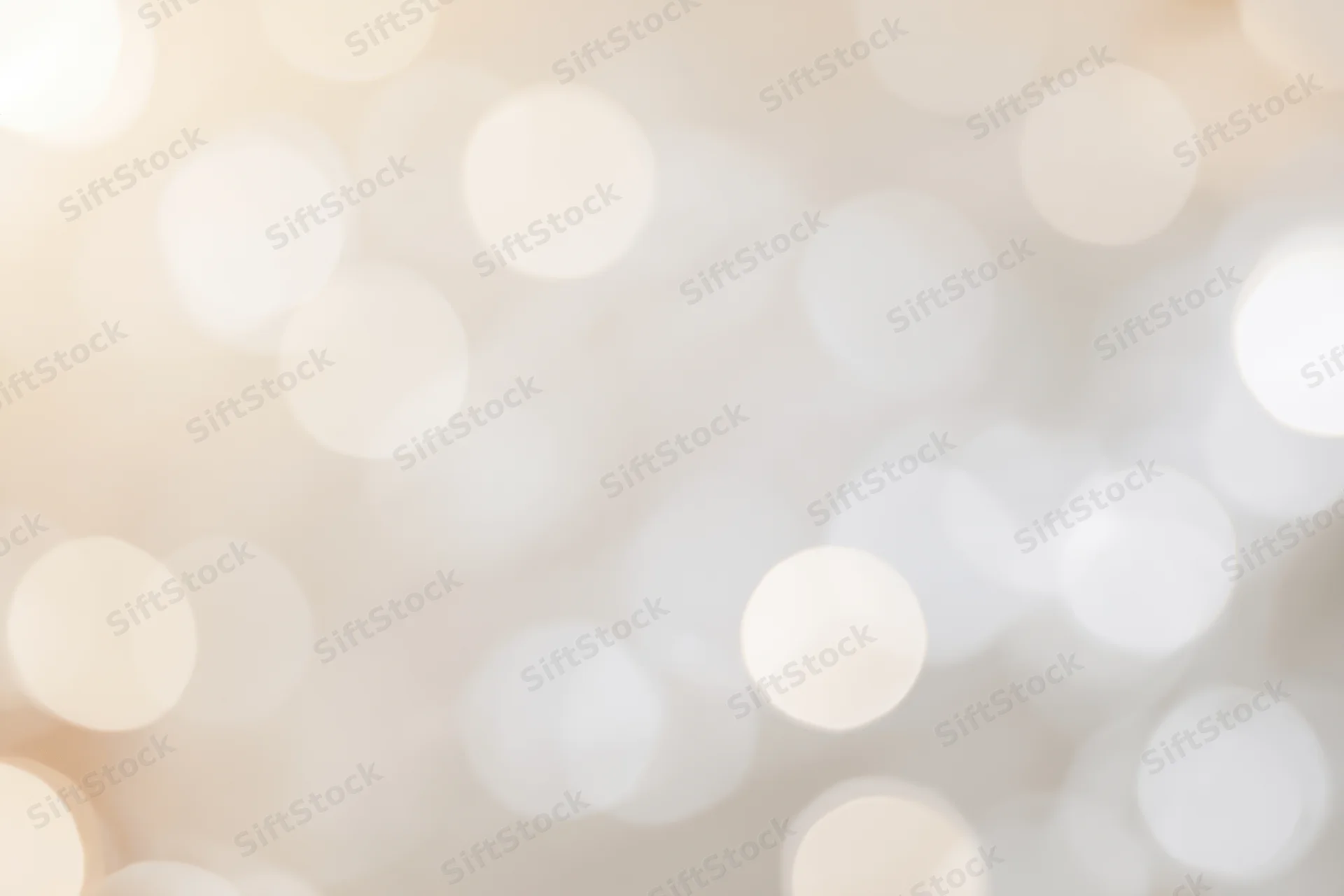 Soft out-of-focus light orbs in warm neutral tones forming an abstract bokeh background