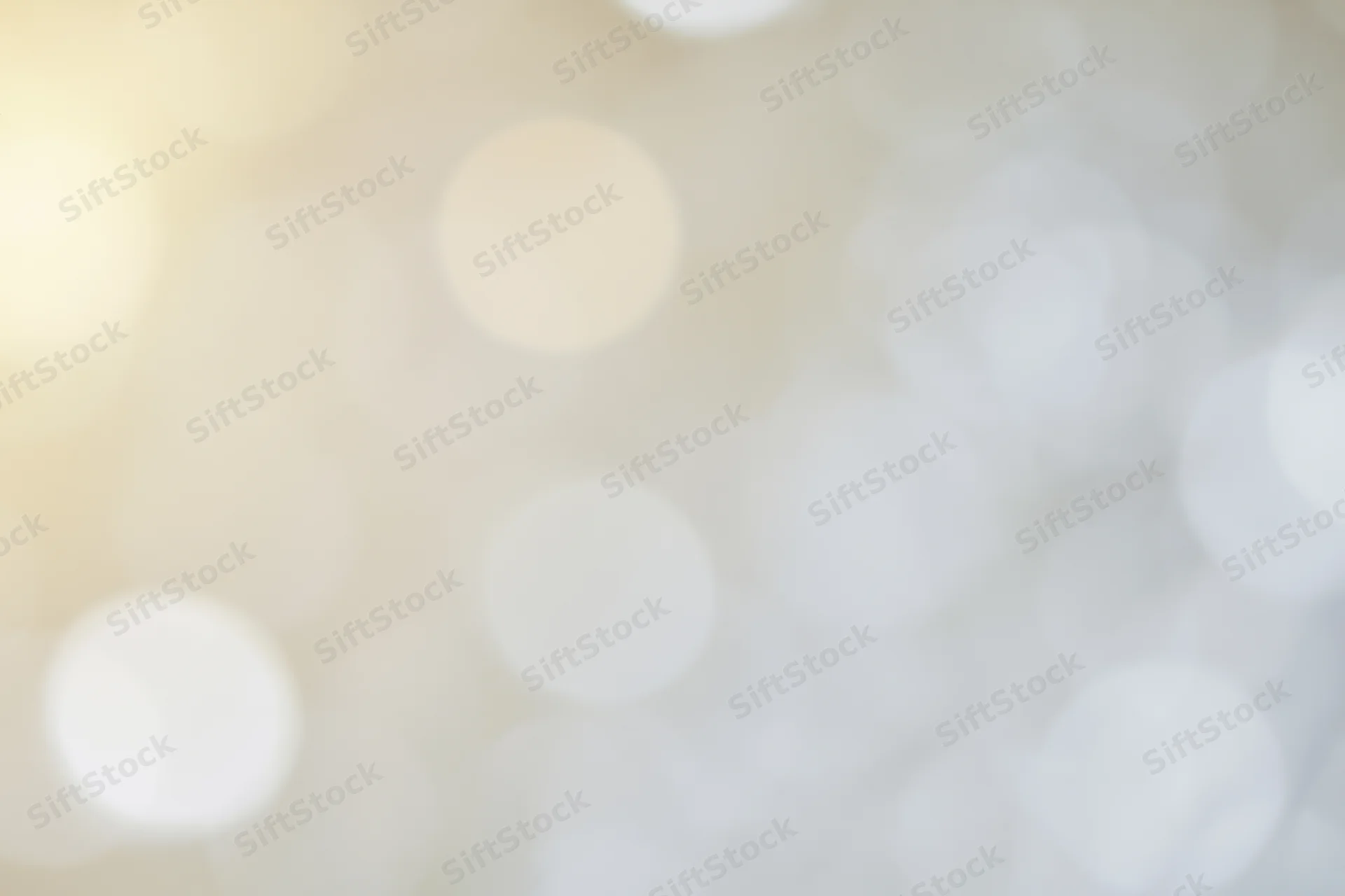Soft out-of-focus light orbs in warm beige and white tones forming an abstract bokeh background