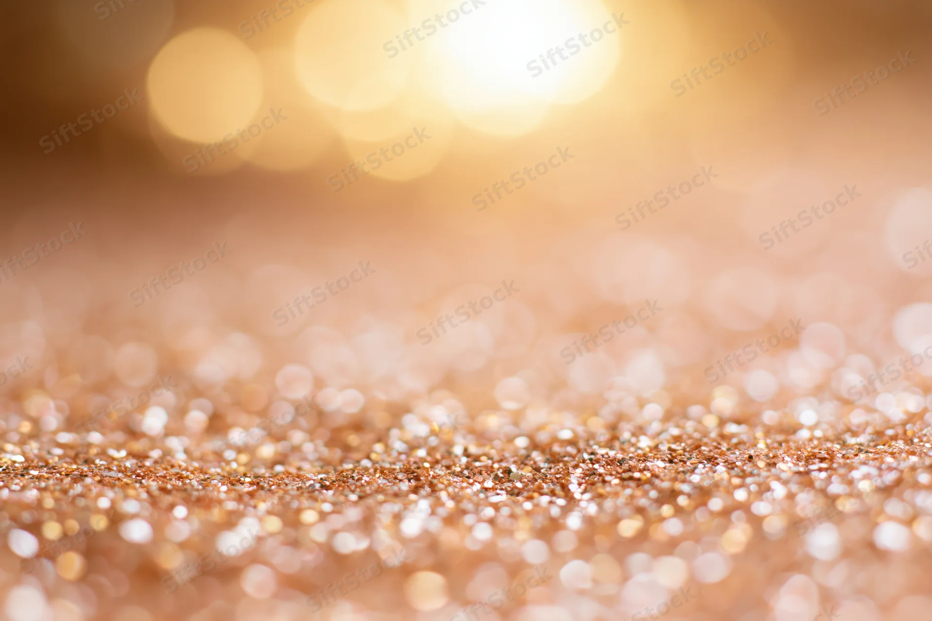 Golden glitter texture with soft bokeh lights in background