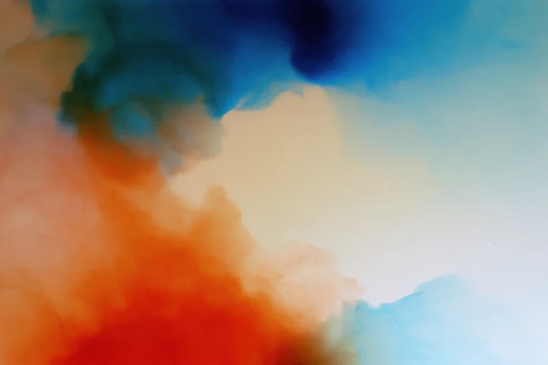 Abstract color gradient with soft blurred ink diffusion forming fluid shapes