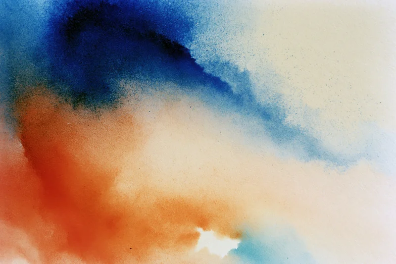 Abstract gradient of blue orange and red hues blending softly across the frame