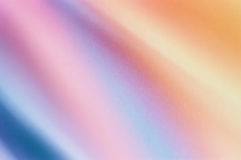 Smooth diagonal gradient of pastel colors blending across the frame as a background texture