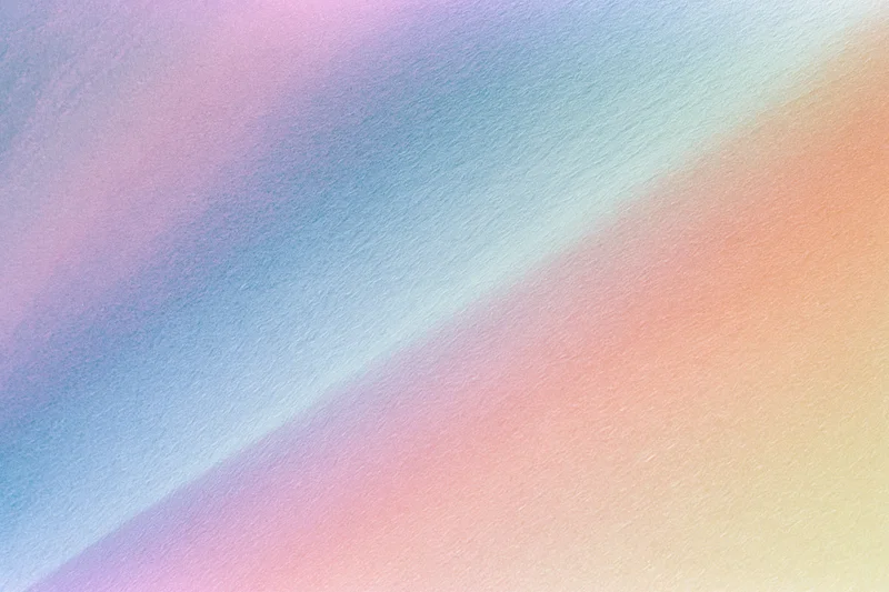 Smooth diagonal gradient of pastel colors blending across textured background