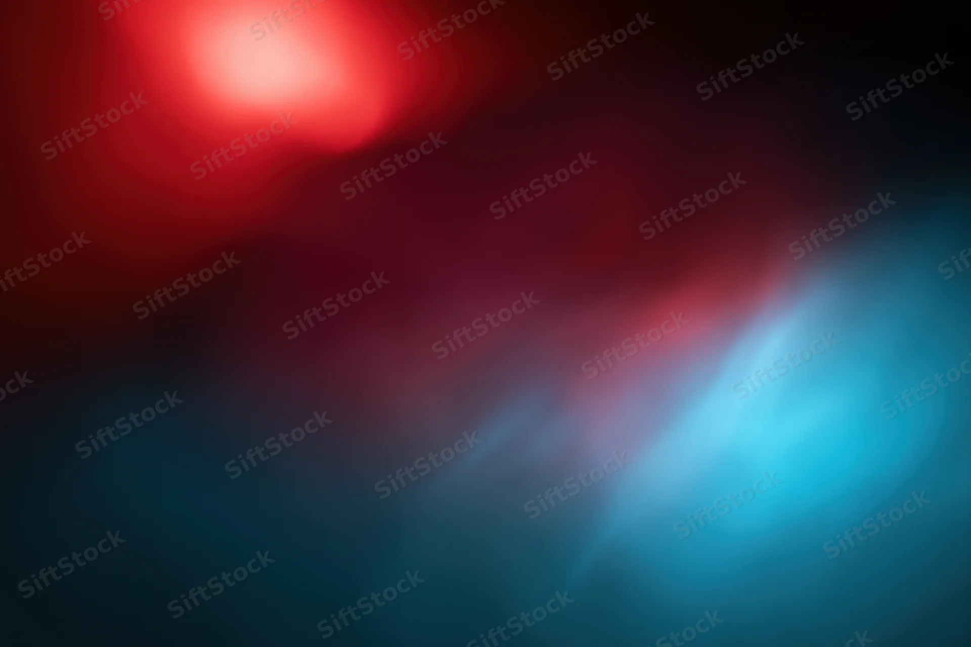 Abstract blurred background with glowing red and blue light sources