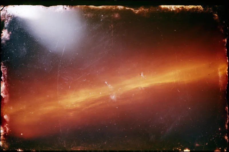 Aged analog film frame with light leak bleeding across the surface