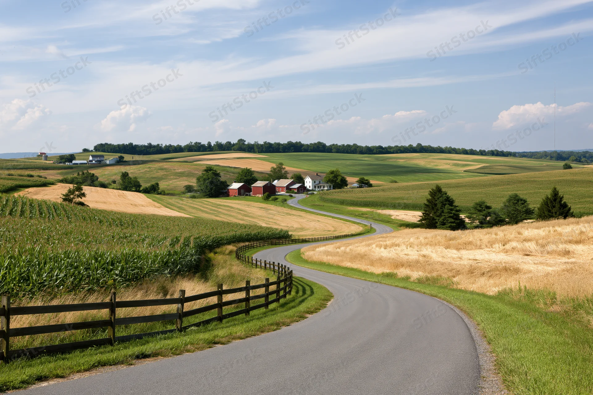 Winding asphalt road through rolling farmland with farmstead and fields in midwestern countryside
