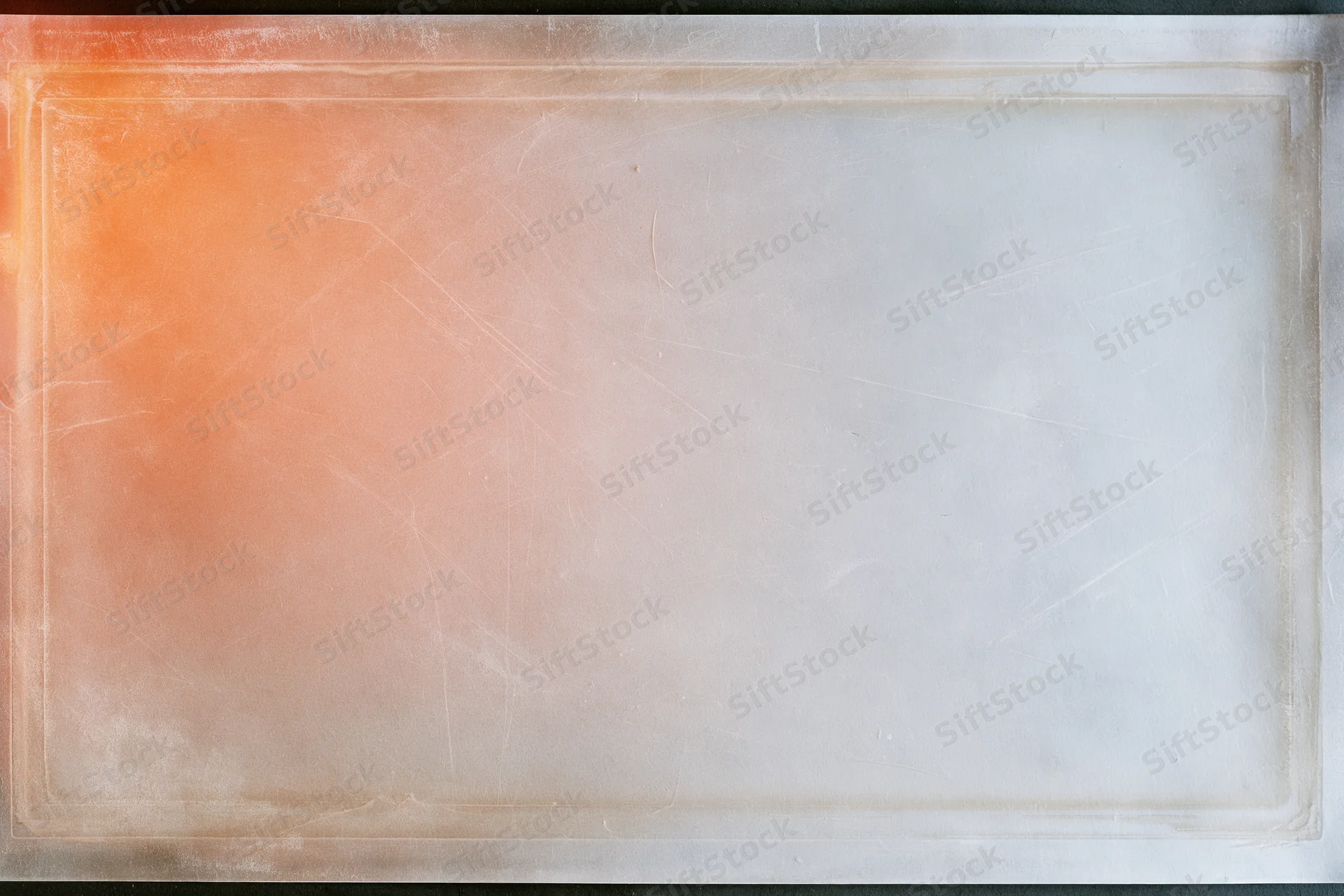 Blank scanned film slide with orange gradient and white center, framed by a thin border