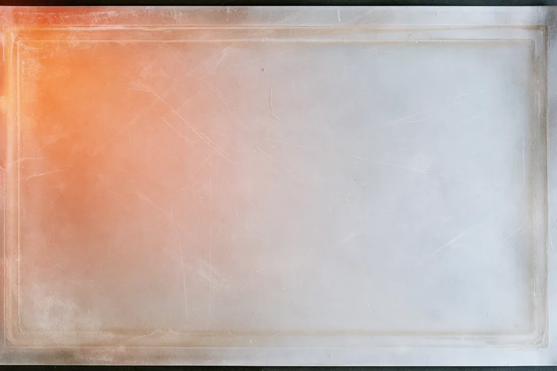 Blank scanned film slide with orange gradient and white center, framed by a thin border