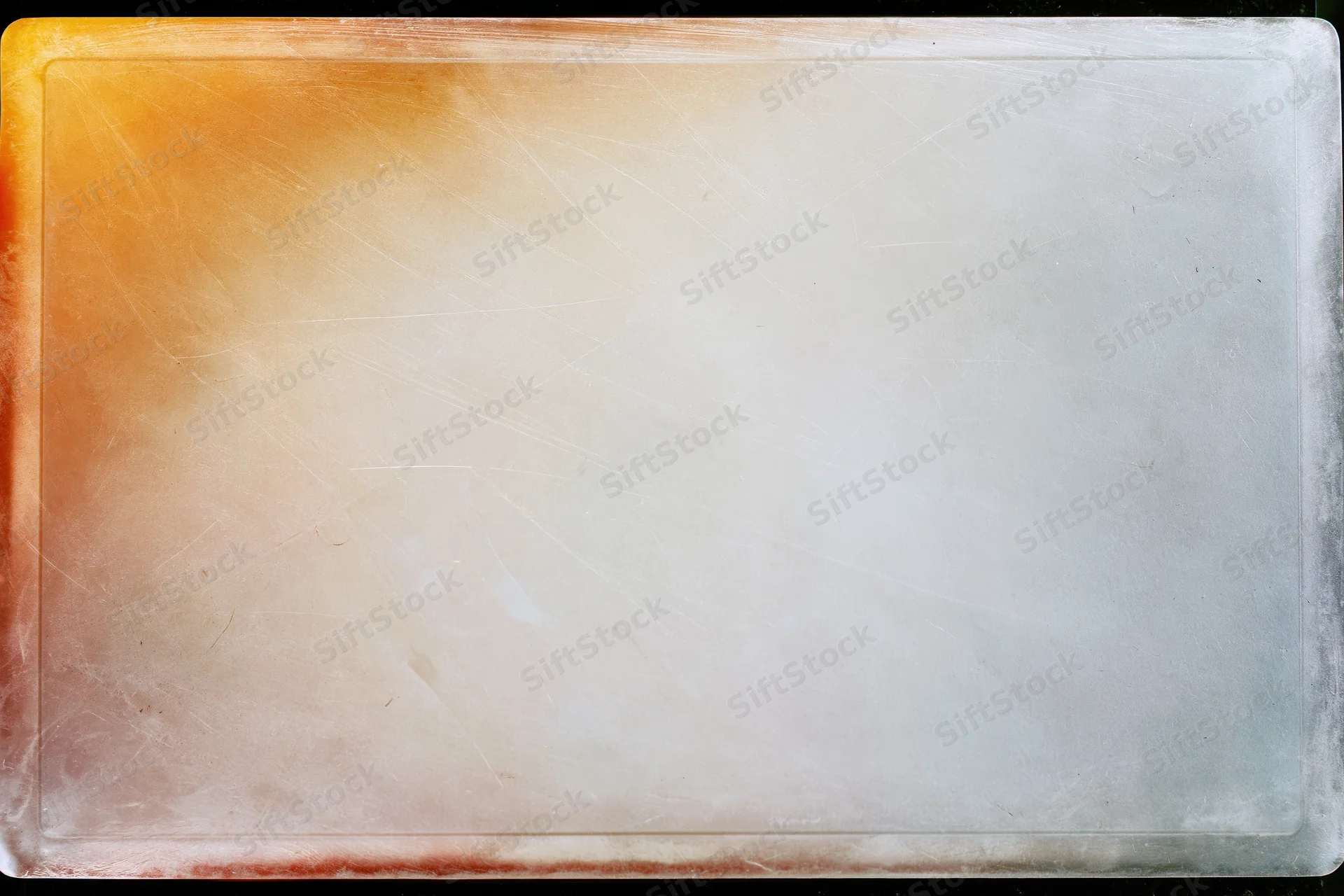 Translucent aged film slide with orange gradient and scratched surface filling frame