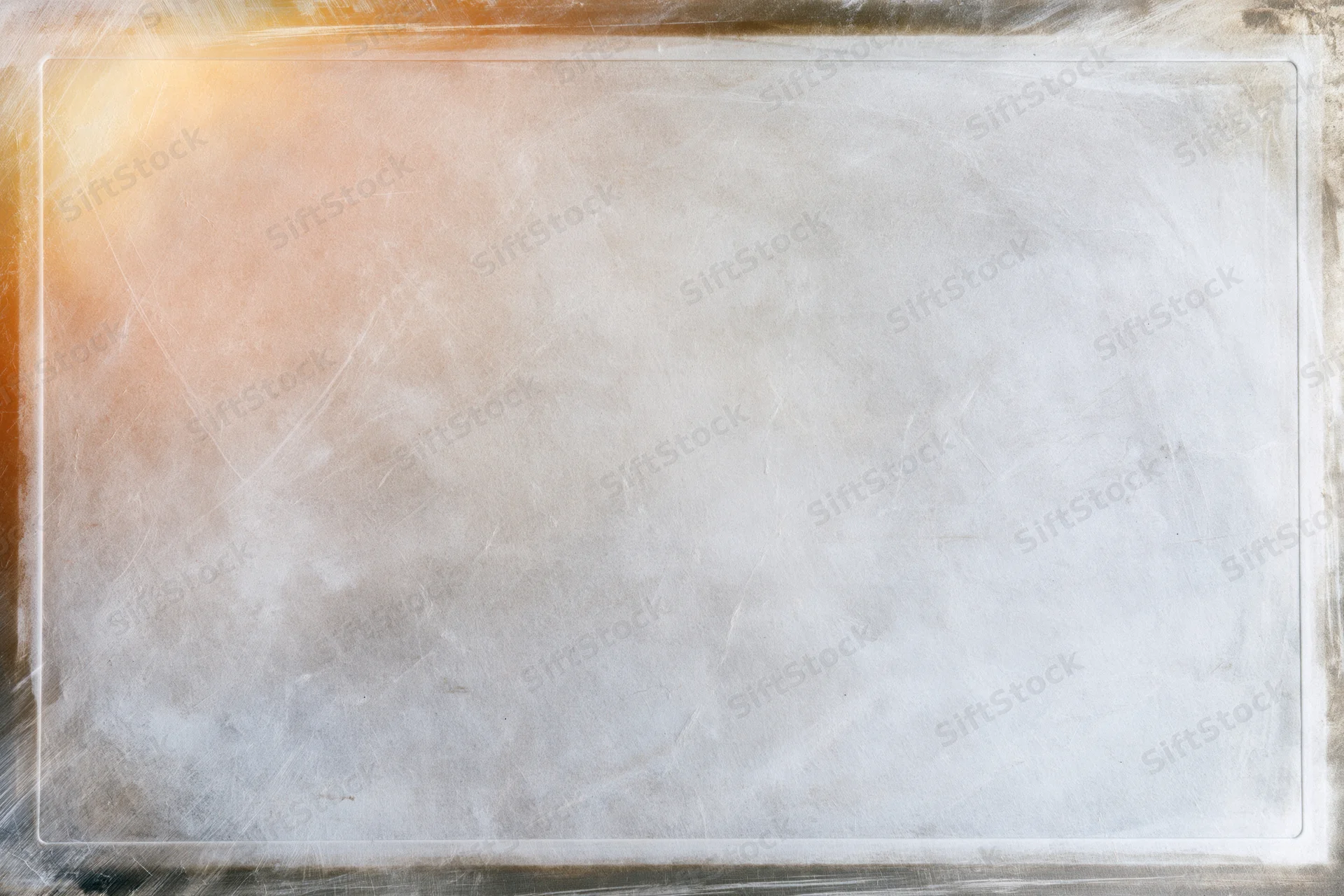 Textured vintage film slide surface with warm glow and border, showing aged paper-like material with scratches and copyspace