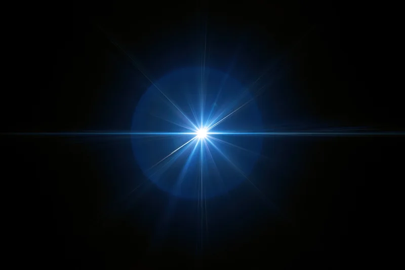 Bright blue lens flare burst centered on pure black background