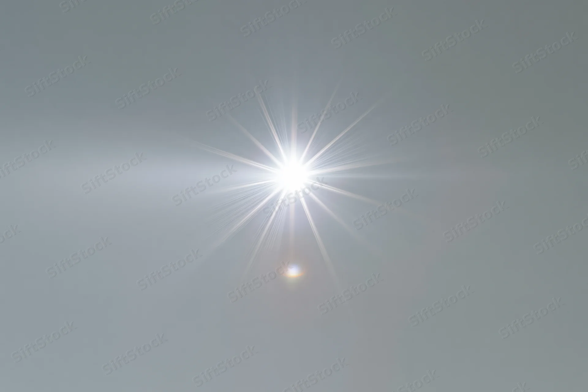Bright lens flare burst centered on a plain light gray background