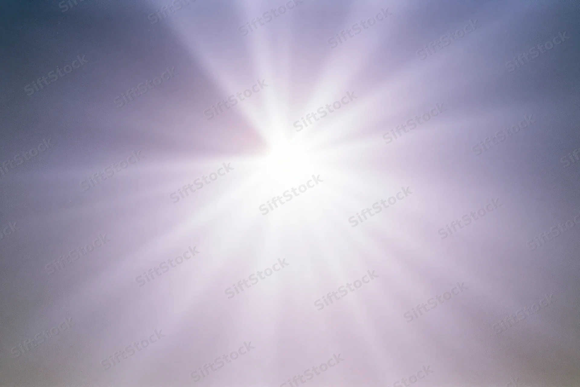 Bright lens flare burst radiating downward rays across a plain gradient background