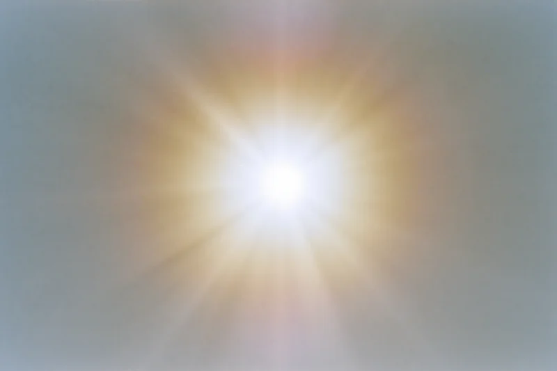 Bright midday sun glowing intensely against a pale white sky