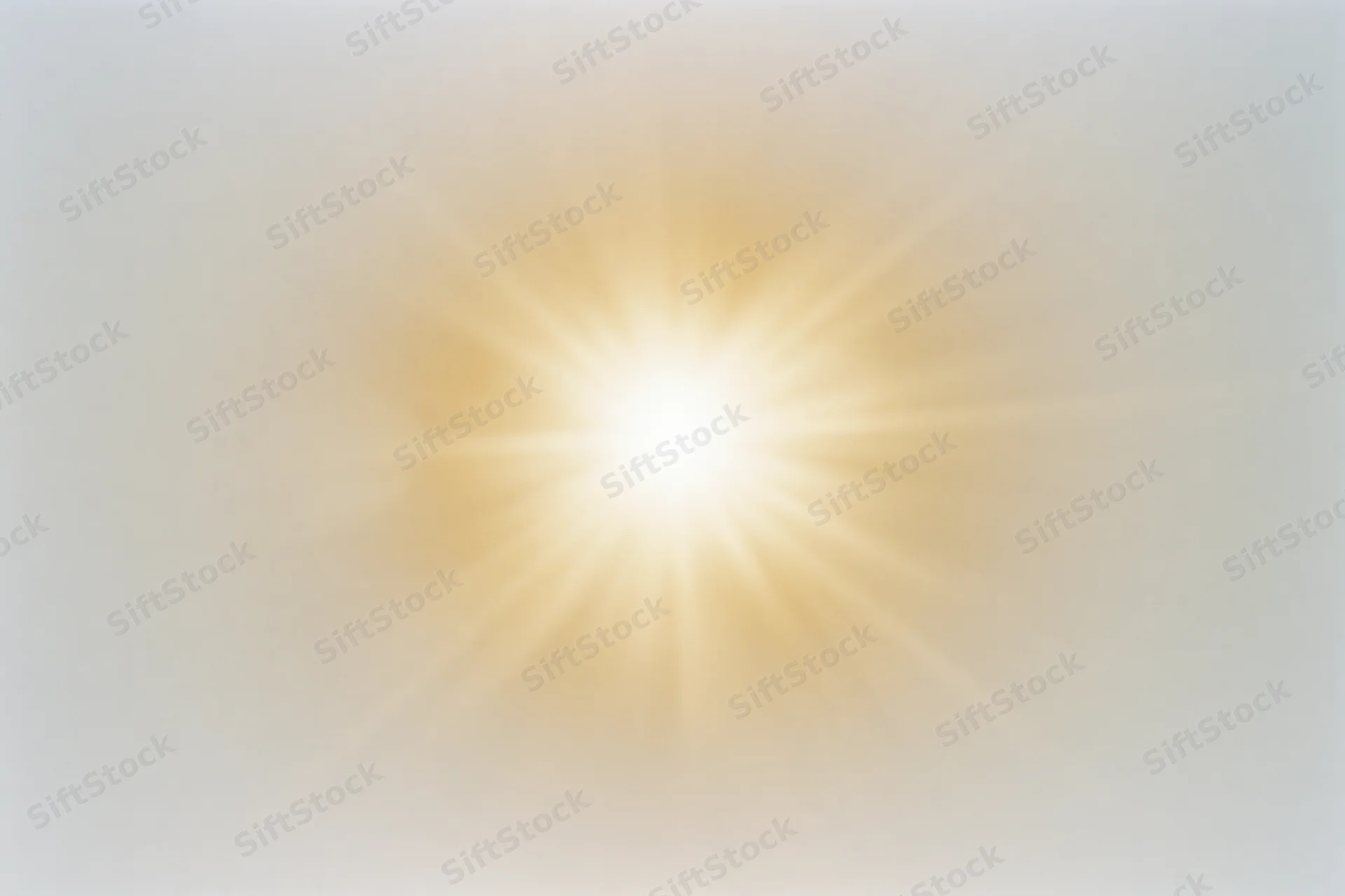 Bright midday sun radiating light against a pale white sky
