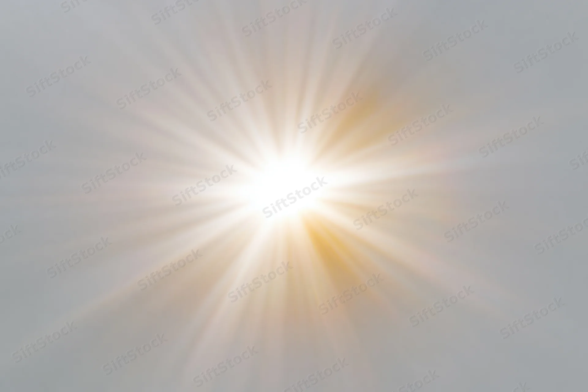 Bright sunburst lens flare radiating light rays from center frame