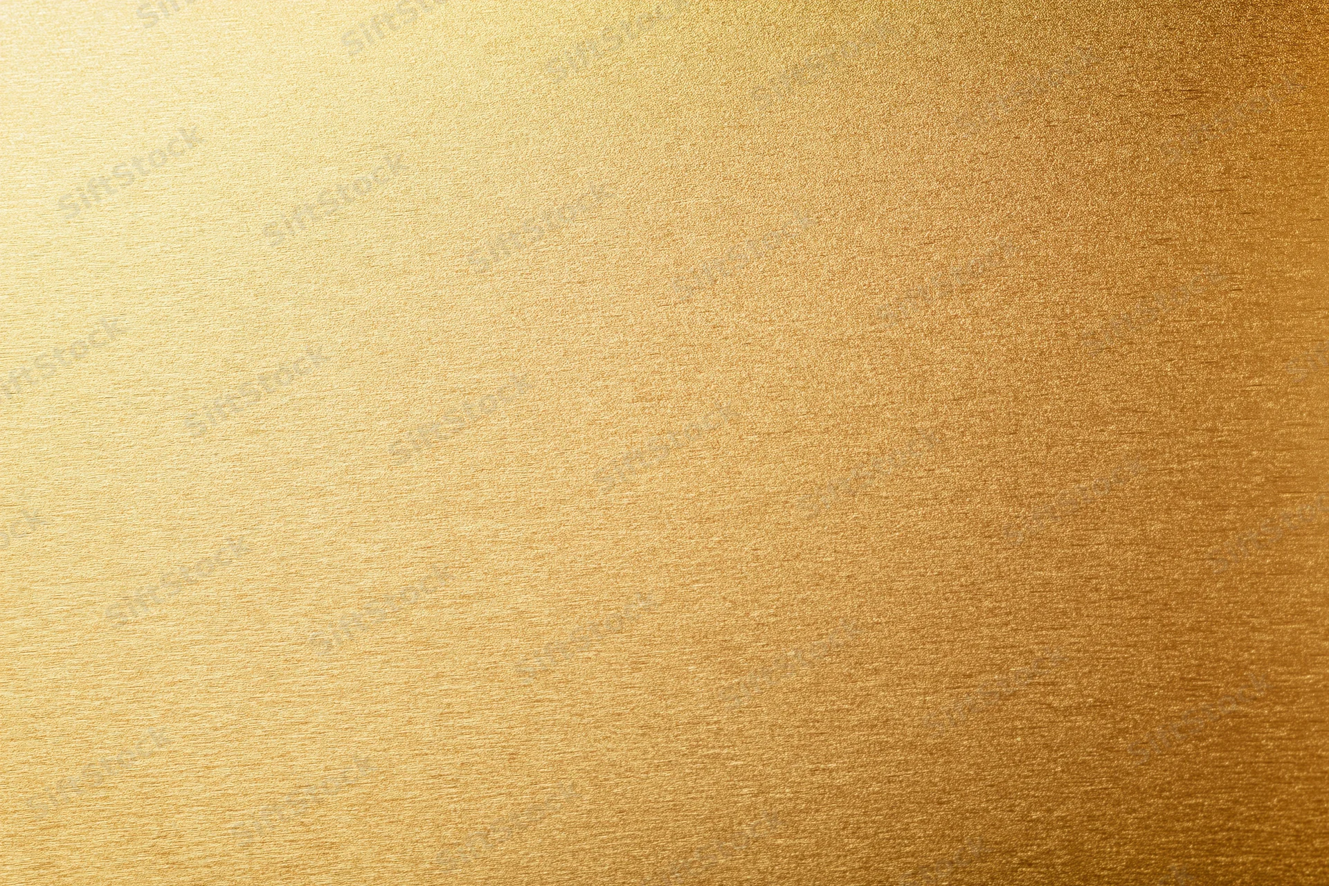 Close-up flat lay of a brushed gold metallic surface filling the frame