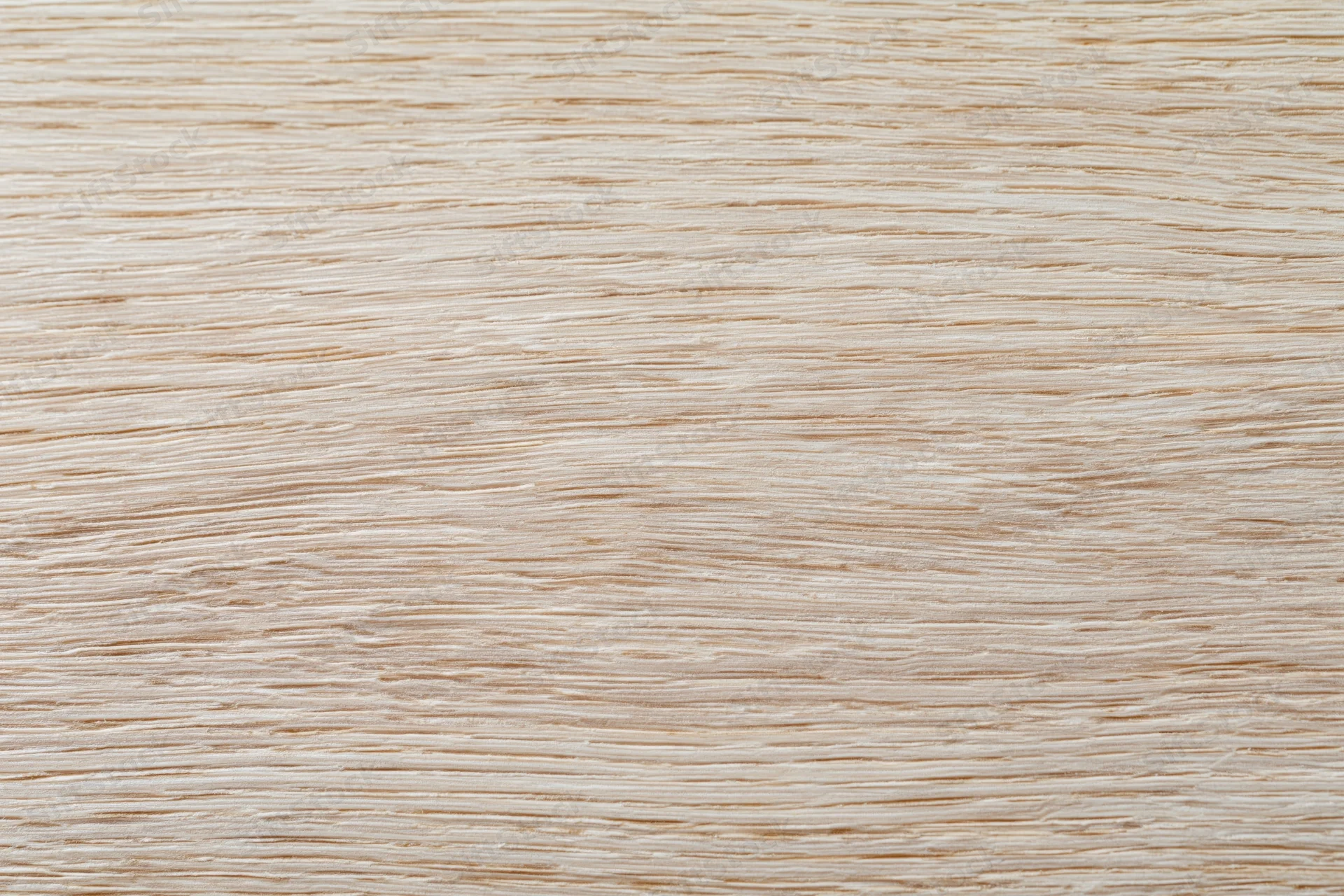 Close-up flat lay of a light bleached oak wood surface showing fine grain texture
