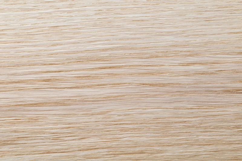 Close-up flat lay of a light bleached oak wood surface with fine grain texture