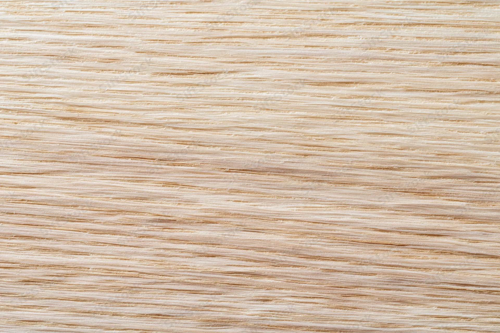 Close-up flat lay of light blonde wood veneer surface showing fine grain texture