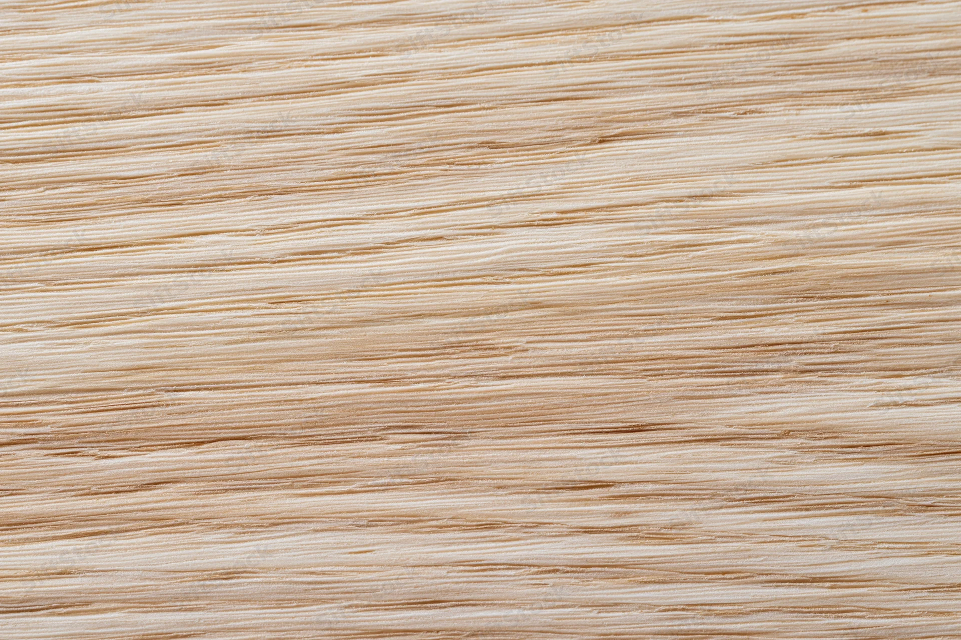 Close-up flat lay of light blonde wood veneer surface showing fine horizontal grain pattern