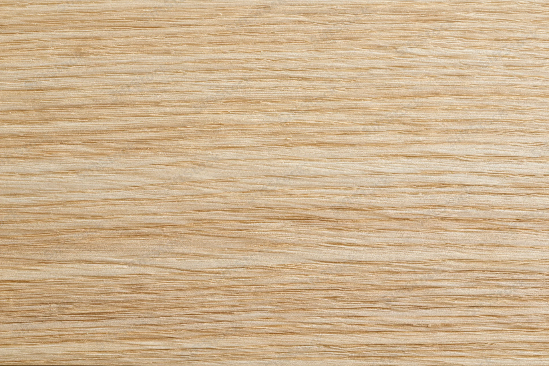 Close-up flat lay of light blonde wood veneer surface showing fine horizontal grain pattern