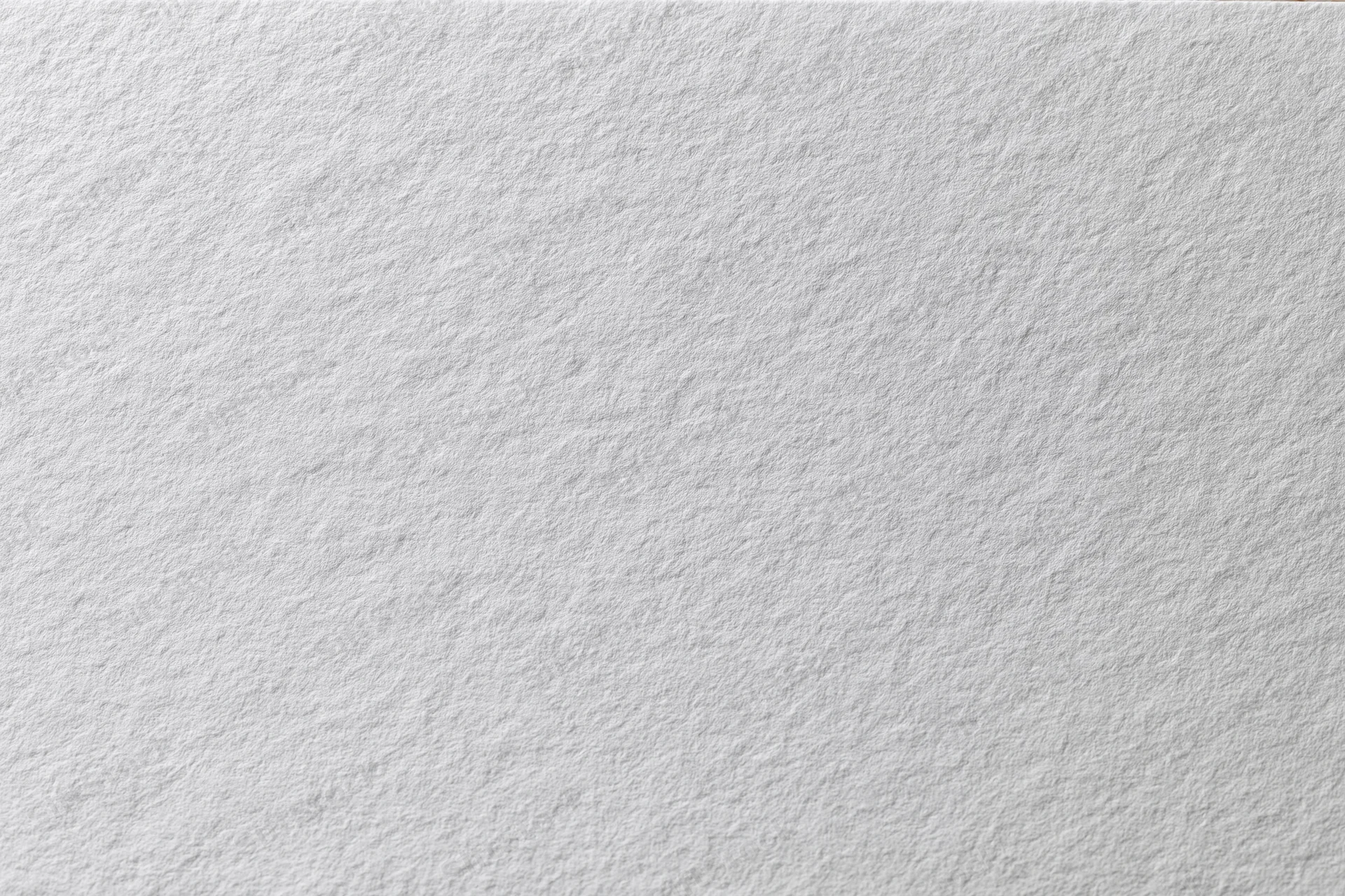 Close-up flat lay of a plain white paper sheet filling the frame