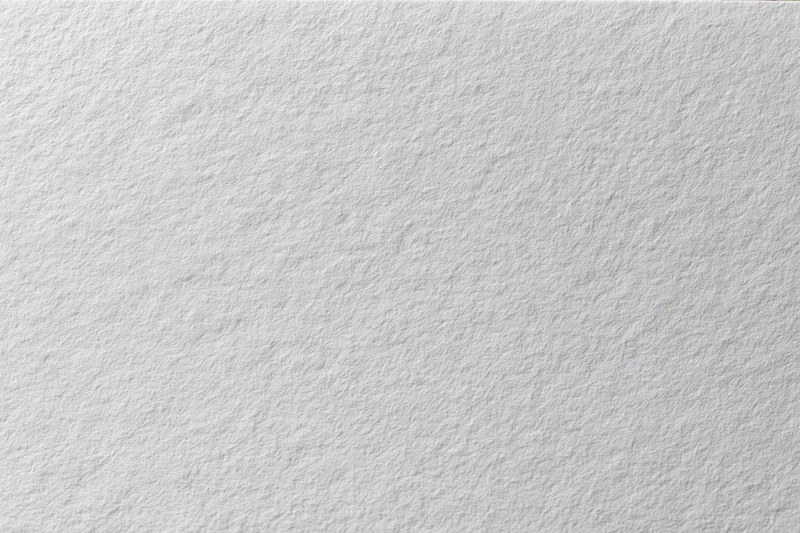 Close-up flat lay of a plain white paper sheet filling the frame