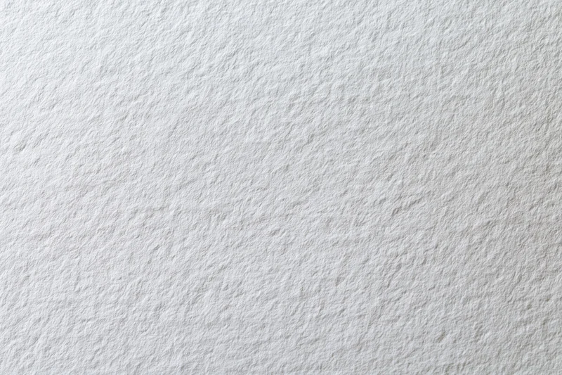 Close-up flat lay of a plain white paper sheet filling the frame