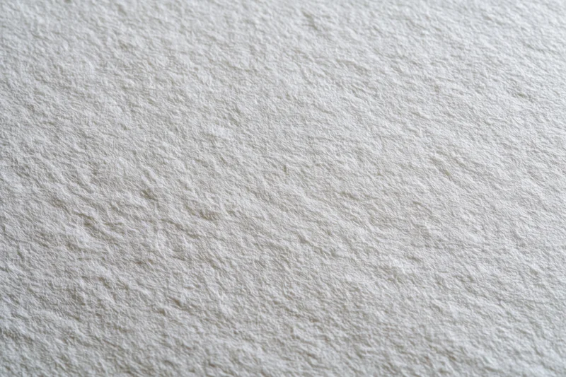 Close-up flat lay of a plain white paper sheet filling the frame