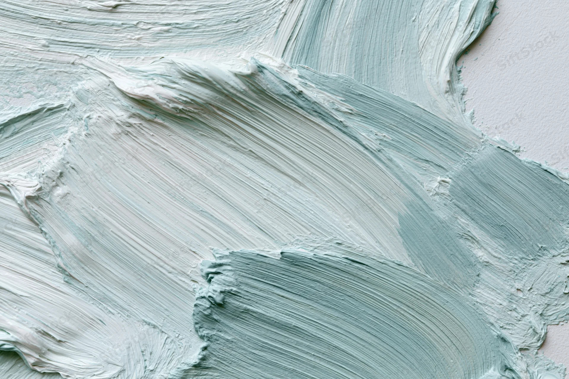 Close-up of thick gestural paint strokes on a white canvas surface