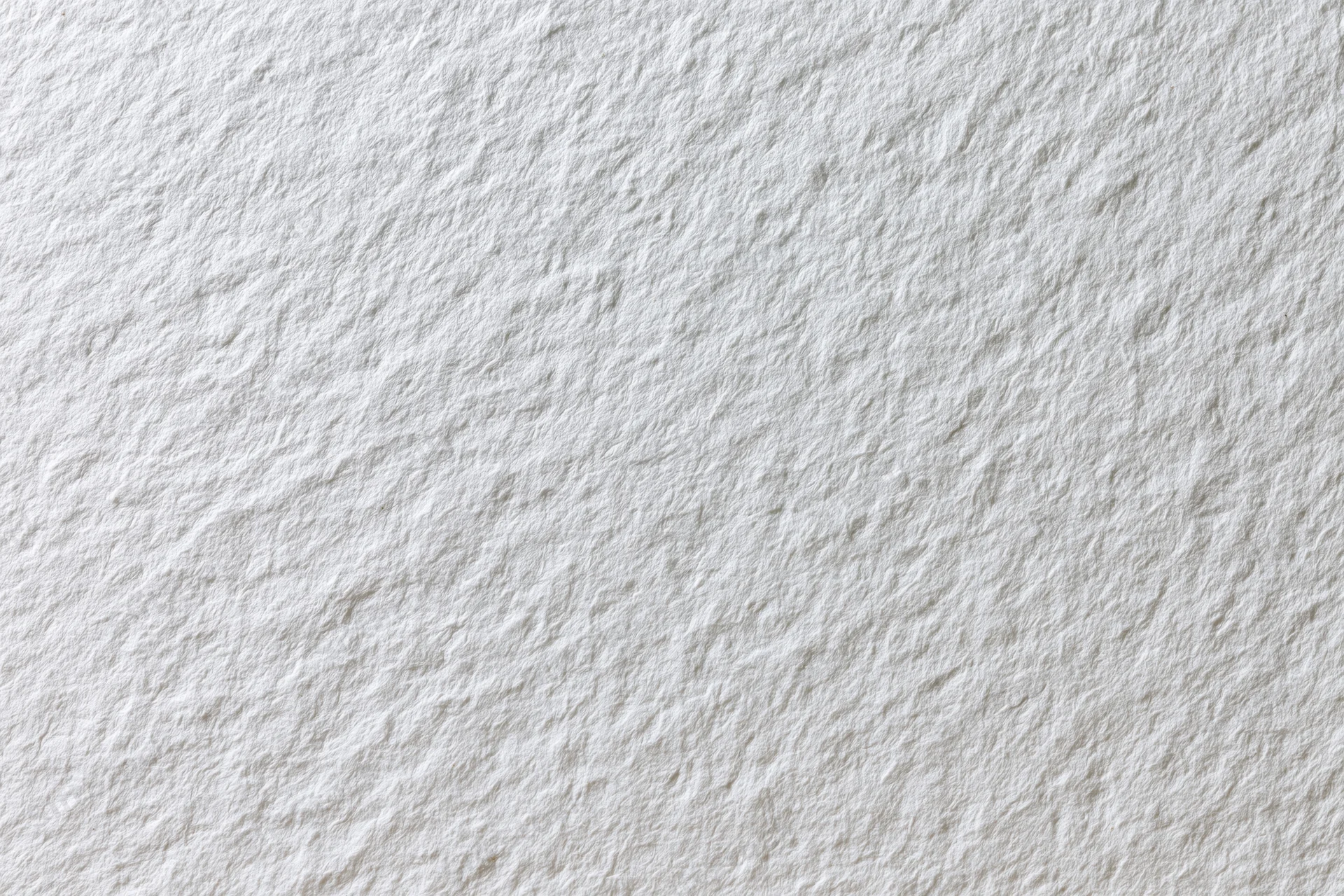 Close-up flat lay of plain white paper texture filling the frame