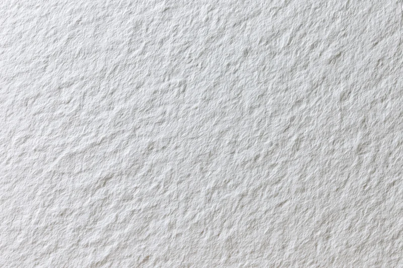 Close-up flat lay of plain white paper texture filling the frame