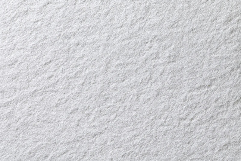 Close-up flat lay of plain white paper texture filling the frame