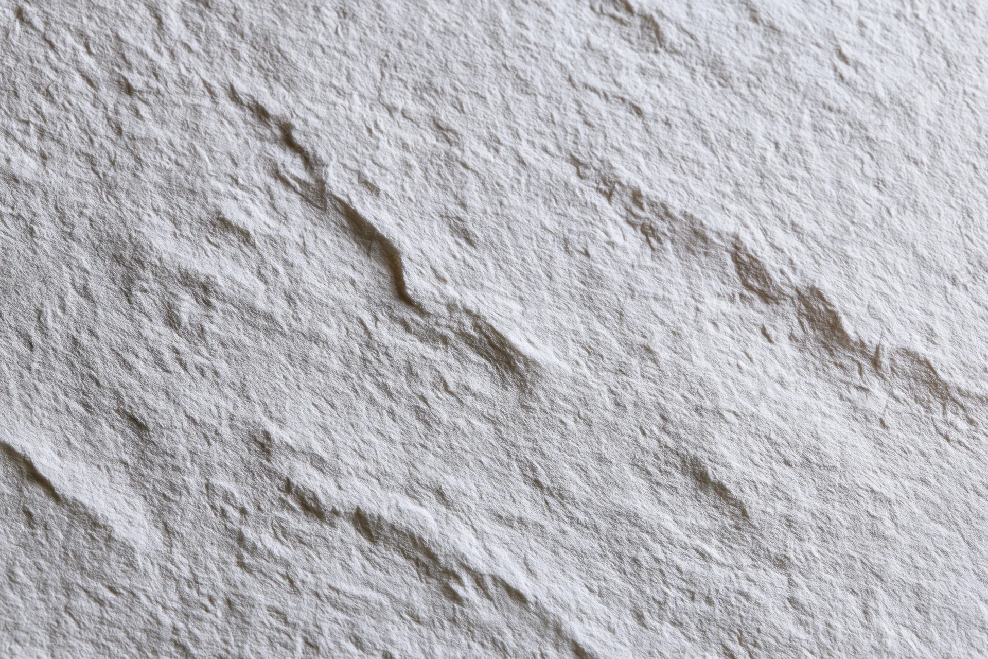 Close-up of white textured paper surface filling the frame
