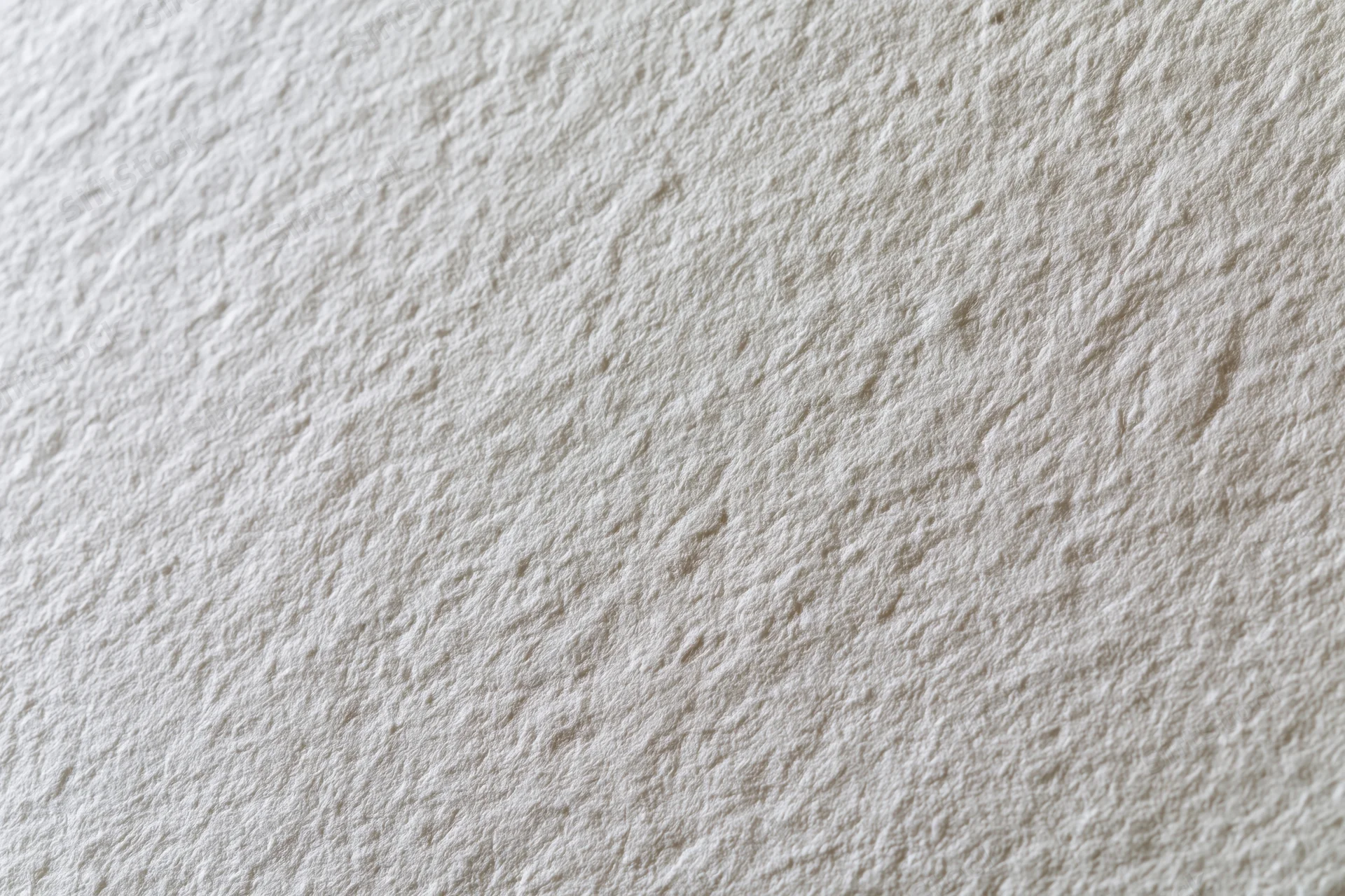 Close-up flat lay of white textured paper surface filling the frame